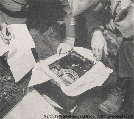 [American officers are shown inspecting a sabotage box filled with supplies for German agents and V-men.]